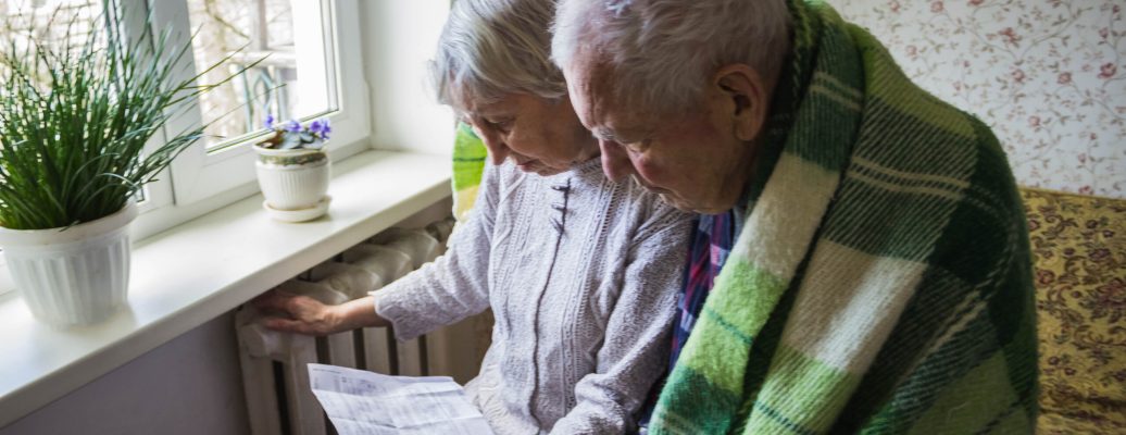 The,Senior,Woman,Holding,Gas,Bill,In,Front,Of,Heating